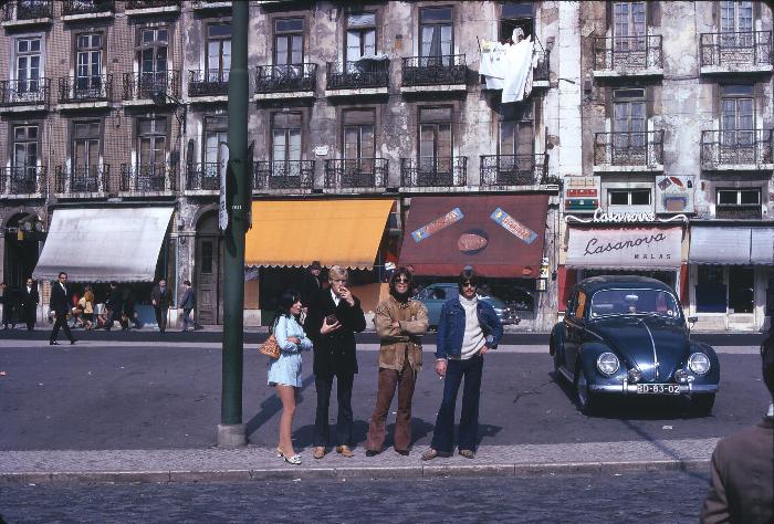 The voyagers and a Beetle pose for a photo in Lisbon